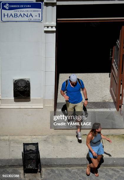 Foreigners leave a post office in Havana after direct mail between Cuba and the United States was re-established, on June 1, 2018. - Direct mail...