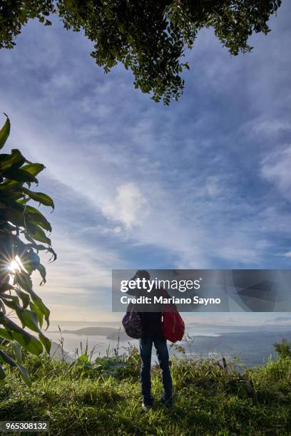 man standing in top of the mountain - tagaytay stock pictures, royalty-free photos & images