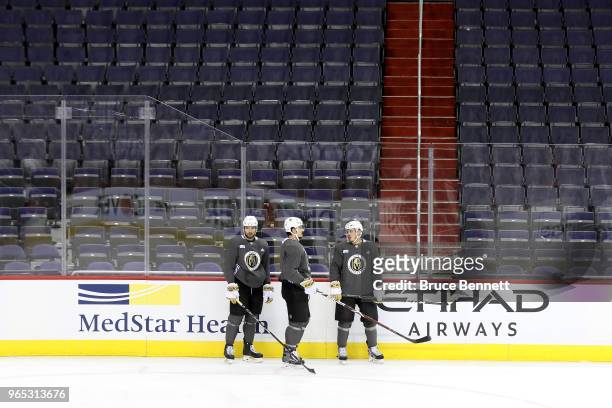 Shea Theodore, Luca Sbisa and Nate Schmidt of the Vegas Golden Knights talk during a practice session for the 2018 NHL Stanley Cup Final at Capital...