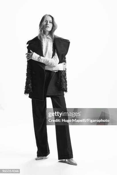 Model Emmy Kruger poses at a fashion shoot for Madame Figaro on October 18, 2017 in Paris, France. Coat by Michael Kors Collection, shirt, suspenders...