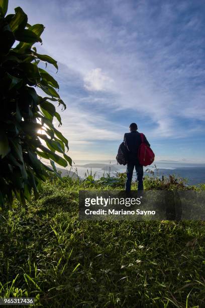 man standing in top of the mountain - tagaytay stock pictures, royalty-free photos & images