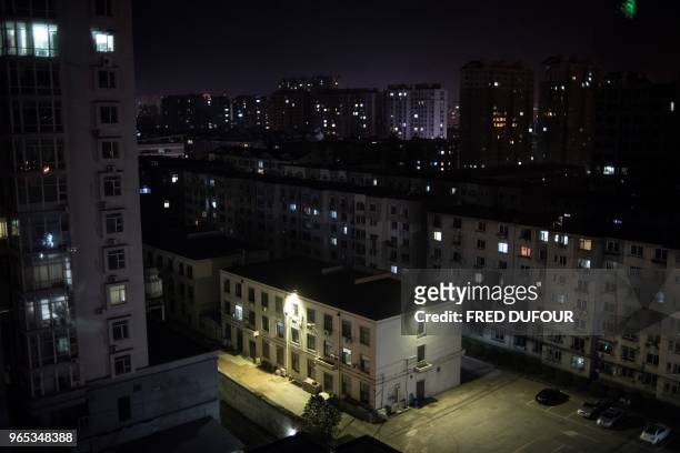 Picture taken at night of the Chinese border town of Dandong, in China's northeast Liaoning province, on May 31, 2018. - The city of Dandong which is...