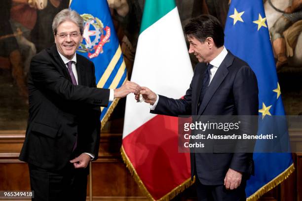 Italy's new Prime Minister Giuseppe Conte rings the bell he received from outgoing Prime Minister Paolo Gentiloni, during the first Ministry Council...