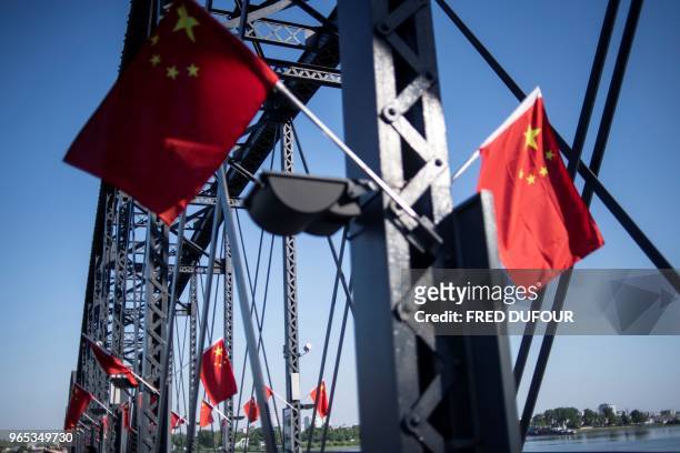 Picture taken from the 'Friendship Bridge' shows Chinese flags in the Chinese border town of Dandong, in China's northeast Liaoning province, on May...