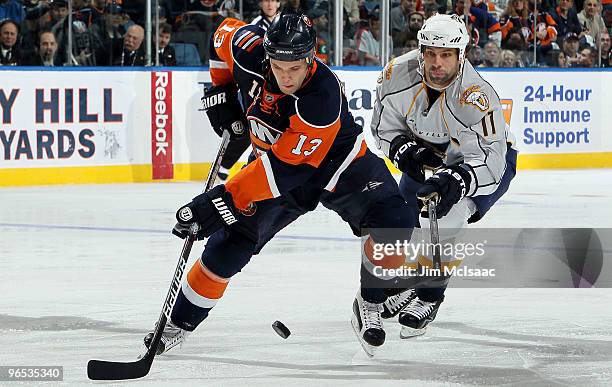 Rob Schremp of the New York Islanders controls the puck against David Legwand of the Nashville Predators on February 9, 2010 at Nassau Coliseum in...