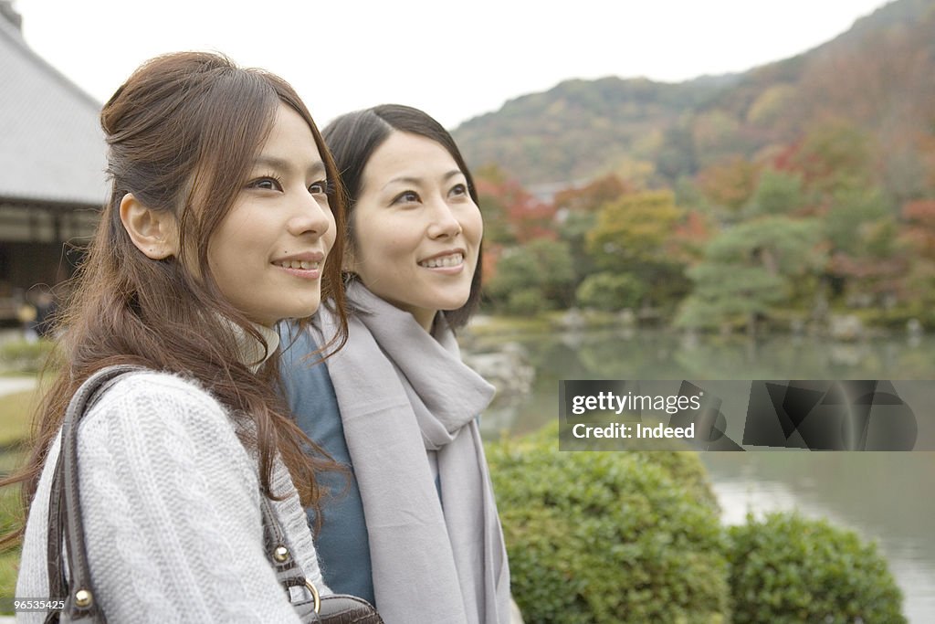 Two women looking away, side view