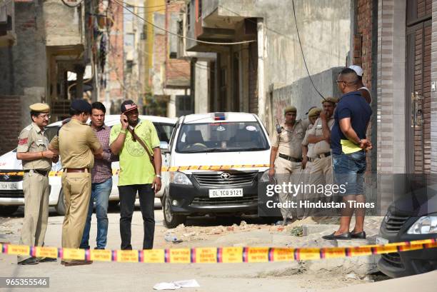 Police officials carry out investigation outside the flat where three African nationals were found dead at Mohan Garden of Uttam Nagar area on June...