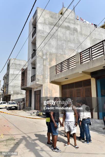 People gather outside a flat where three African nationals were found dead at Mohan Garden of Uttam Nagar area on June 1, 2018 in New Delhi, India....