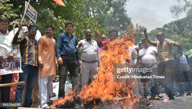 Leaders and workers burn an effigy of West Bengal CM Mamata Banerjee protesting against the murder of the 21-year-old BJP worker Trilochan Mahato at...