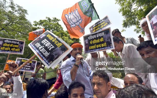 Delhi State BJP President Manoj Tiwari and other workers protest against the murder of the 21-year-old BJP worker Trilochan Mahato at Supurdi village...