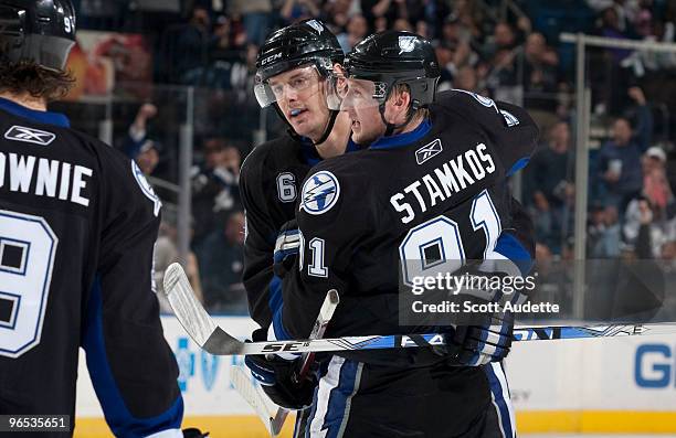 Steven Stamkos of the Tampa Bay Lightning celebrates his goal with teammate Kurtis Foster during the first period against the Vancouver Canucks at...