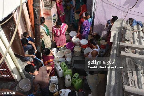 Residents line up their empty buckets and cans to fill up water at J. P. Camp of RK Puram on June 1, 2018 in New Delhi, India.