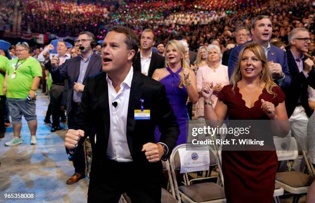 Doug McMillon, Walmart CEO, does the Walmart "squiggly" with wife Shelley during the annual shareholders meeting event on June 1, 2018 in...