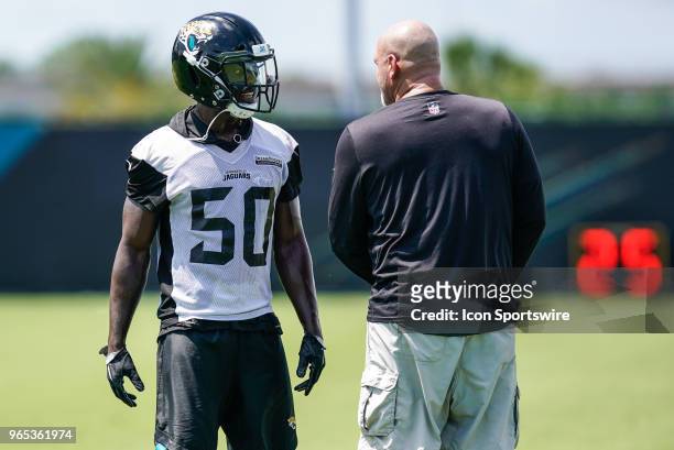 Jacksonville Jaguars linebacker Telvin Smith chats with Jacksonville Jaguars defensive coordinator Todd Walsh during the Jaguars OTA on June 1, 2018...