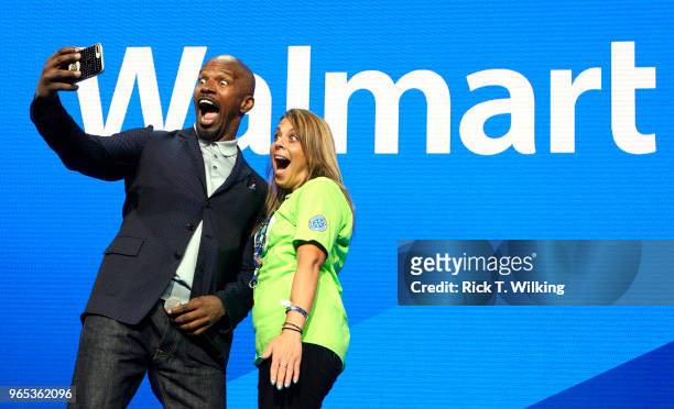 Host Jamie Foxx takes a selfie onstage with a Sam's Club associate during the annual shareholders meeting event on June 1, 2018 in Fayetteville,...