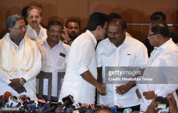 Congress leader K C Venugopal speaks to Chief Minister of Karnataka Kumarswamy as Dy. Chief Minister Parmeshwara and former Chief Minister...