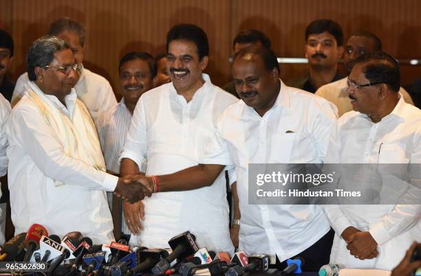 Congress leader K C Venugopal shares a light moment with former Chief Minister Siddaramaiah in the prersence of Dy. Chief Minister Parmeshwara and...