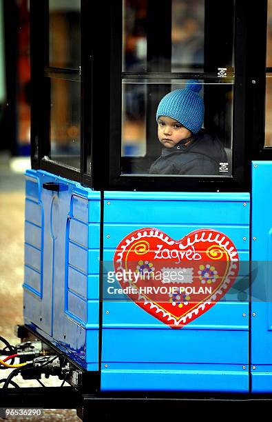 Kid is pictured in a carriage in the traditional Zagreb�s �fake kid� tramway at the main capital square on January 22, 2010. While the kid is sitting...