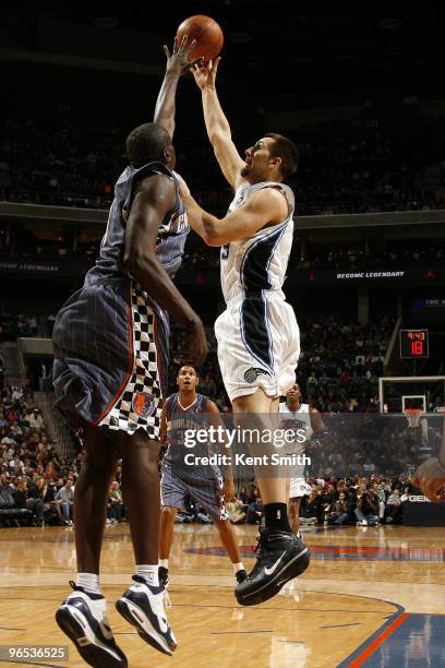 Ryan Anderson of the Orlando Magic goes up for a shot against DeSagana Diop of the Charlotte Bobcats during the game at Time Warner Cable Arena on...