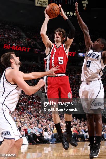 Rudy Fernandez of the Portland Trail Blazers goes up for a shot against Mehmet Okur and Ronnie Brewer of the Utah Jazz during the game at The Rose...