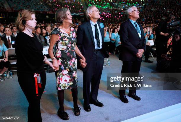 Members of the Walton family Alice, Jim and Rob, wait with a stagehand to go onstage during the annual shareholders meeting event on June 1, 2018 in...