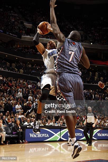 Vince Carter of the Orlando Magic goes up for a shot against DeSagana Diop of the Charlotte Bobcats during the game at Time Warner Cable Arena on...