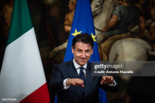 New Italian Prime Minister Giuseppe Conte receives a silver bell from former Prime Minister Paolo Gentiloni during the swearing-in ceremony at the...