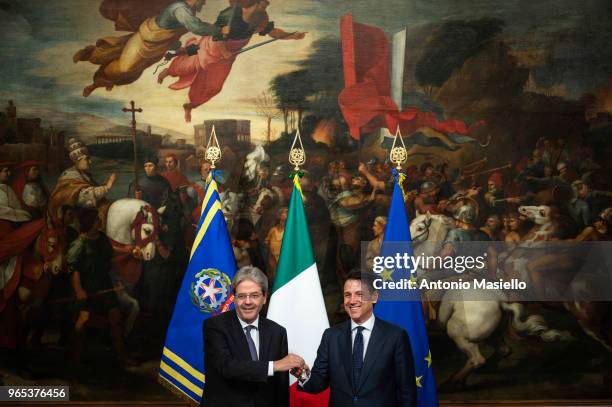 New Italian Prime Minister Giuseppe Conte receives a silver bell from former Prime Minister Paolo Gentiloni during the swearing-in ceremony at the...