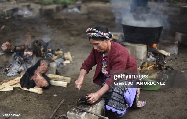 Woman prepares food during the wake of Claudia Gomez, a 19-year-old Guatemalan woman who was allegedly shot and killed by a US border patrol agent,...