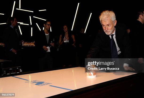 Actor John Slattery plays air hockey at the after party for the Opening of the first Hermes Men's Store on Madison Avenue at NY State Armory on...