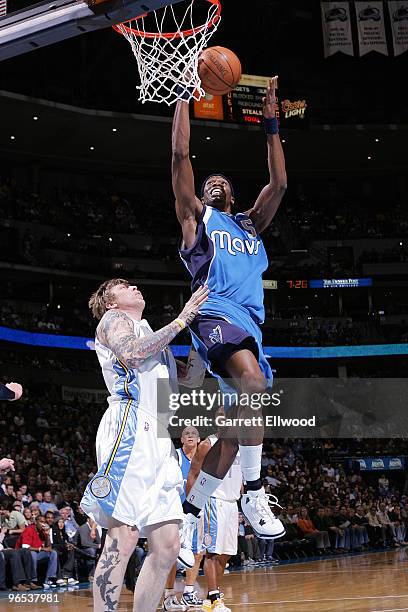 Josh Howard the Dallas Mavericks goes to the basket against Chris Andersen of the Denver Nuggets on February 9, 2010 at the Pepsi Center in Denver,...