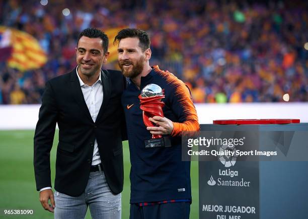 Xavi Hernandez gives Lionel Messi of Barcelona the trophy to the best player of the month prior the La Liga match between Barcelona and Real Sociedad...