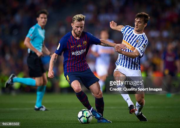 Ivan Rakitic of Barcelona competes for the ball with LLorente of Real Sociedad during the La Liga match between Barcelona and Real Sociedad at Camp...