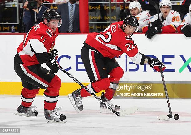 Chris Kelly of the Ottawa Senators chips the puck forward to teammate Daniel Alfredsson in an NHL game against the Calgary Flames at Scotiabank Place...