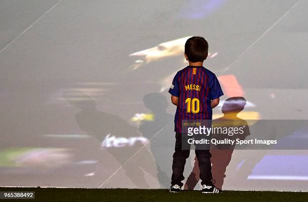 Thiago Messi looks at the screen the image of his father Lionel Messi of FC Barcelona after the La Liga match between Barcelona and Real Sociedad at...