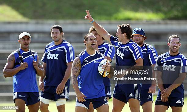 Mike Harris celebrates with Luke McAlister after winning a game during a Blues Super 14 training session at Unitec on February 10, 2010 in Auckland,...