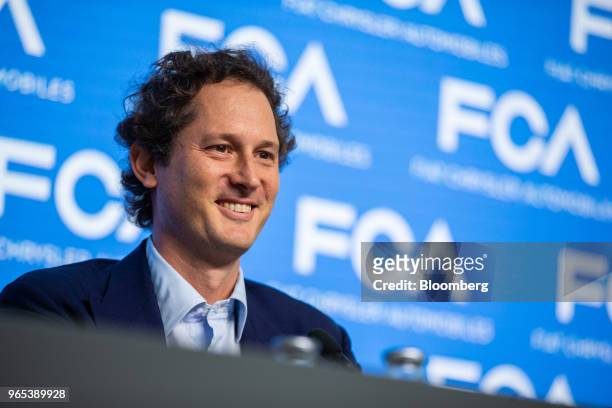 John Elkann, chairman of Fiat Chrysler Automobiles NV, smiles during a news conference with Sergio Marchionne, chief executive officer of Fiat...
