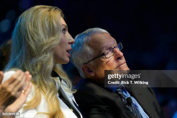 Rob Walton's wife Melani Lowman Walton speaks to Rob Walton during the annual Walmart shareholders meeting event on June 1, 2018 in Fayetteville,...