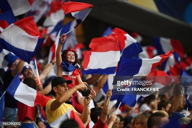 France's supporters waves flags before the friendly football match between France and Italy at the Allianz Riviera Stadium in Nice, southeastern...