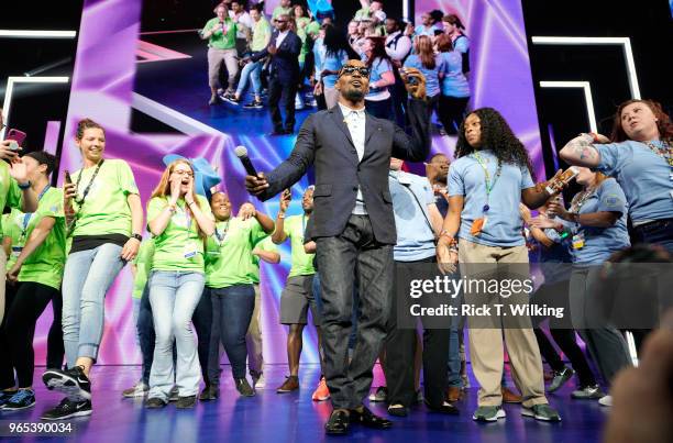 Host Jamie Foxx dances onstage with Walmart associates during the annual shareholders meeting event on June 1, 2018 in Fayetteville, Arkansas. The...