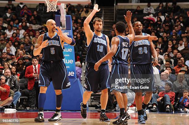 Carlos Boozer, Mehmet Okur, Ronnie Price and C.J. Milles of the Utah Jazz celebrate as they walk off the court during the game against the Los...