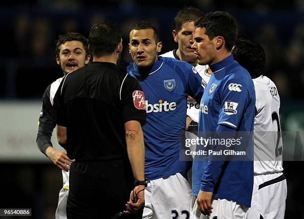 Hassan Yebda of Portsmouth protests his innocence to referee Kevin Friend after he was sent off instead of Ricardo Rocha however the decision was...