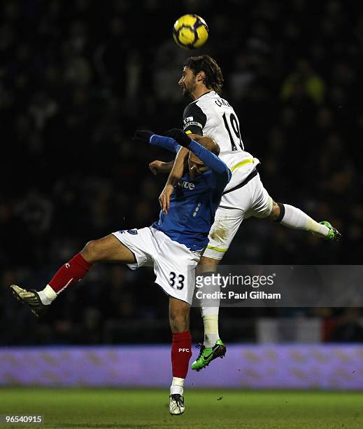 Angelo Basinas of Portsmouth battles for the ball with Lorik Cana of Sunderland during the Barclays Premier League match between Portsmouth and...
