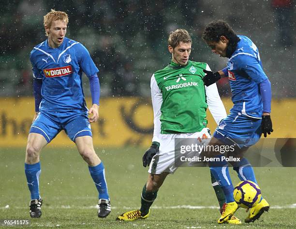 Aaron Hunt of Bremen and Carlos Eduardo and Andreas Ibertsberger of Hoffenheim battle for the ball during the DFB Cup quarter final match between SV...