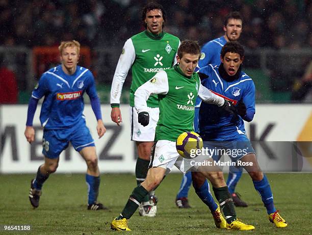 Marko Marin of Bremen and Carlos Eduardo of Hoffenheim battle for the ball during the DFB Cup quarter final match between SV Werder Bremen and 1899...