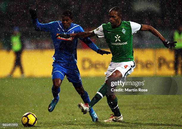 Naldo of Bremen and Maicosuel of Hoffenheim battle for the ball during the DFB Cup quarter final match between SV Werder Bremen and 1899 Hoffenheim...