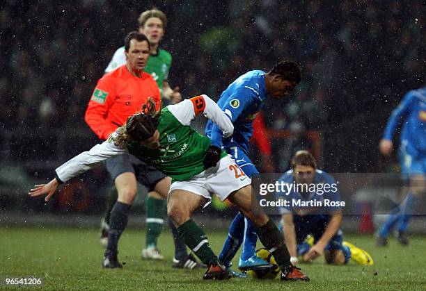 Torsten Frings of Bremen and Maicosuel of Hoffenheim battle for the ball during the DFB Cup quarter final match between SV Werder Bremen and 1899...