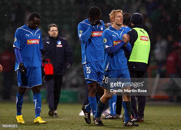 Prince Tagoe, Isaac Vorsah and Andreas Ibertsberger of Hoffenheim looks dejected after the DFB Cup quarter final match between SV Werder Bremen and...