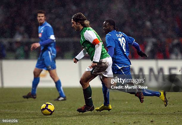 Torsten Frings of Bremen and Prince Tagoe of Hoffenheim battle for the ball during the DFB Cup quarter final match between SV Werder Bremen and 1899...