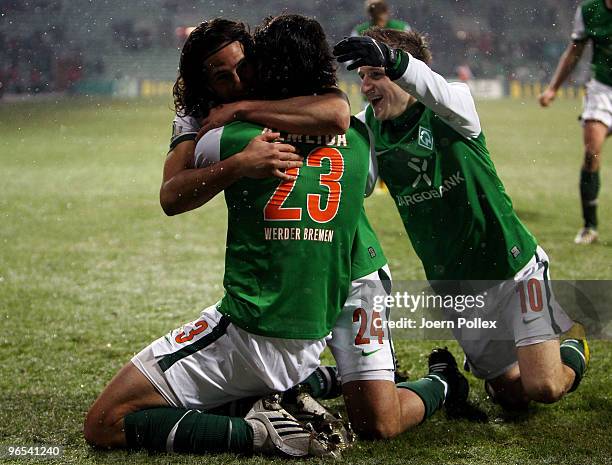 Hugo Almeida of Bremen celebrates with his team mates Claudio Pizarro and Marko Marin after scoring his team's second goal during the DFB Cup quarter...